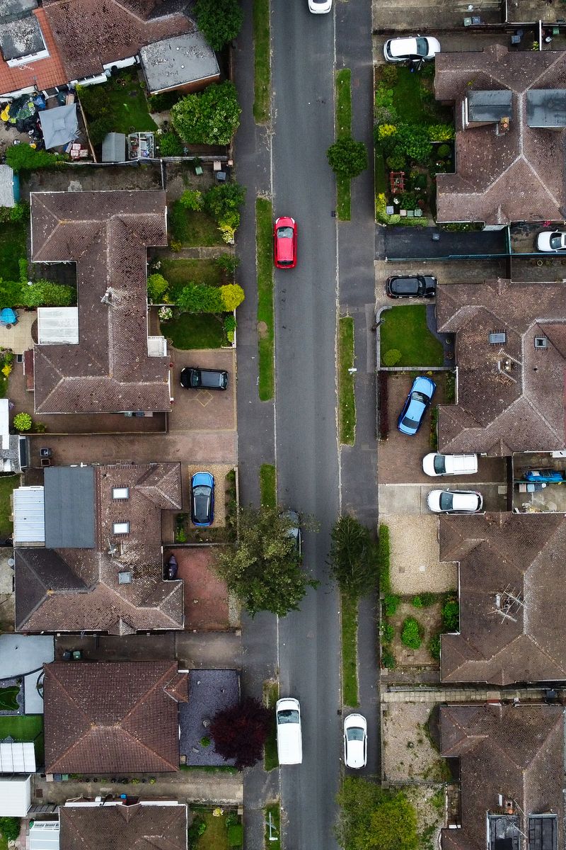 Drone shot capturing the houses and streets in a suburban area of Luton, England.